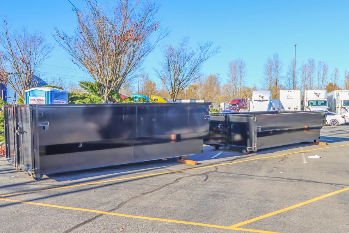 Professional dumpster rental service with roll-off container on residential driveway in North Palm Beach